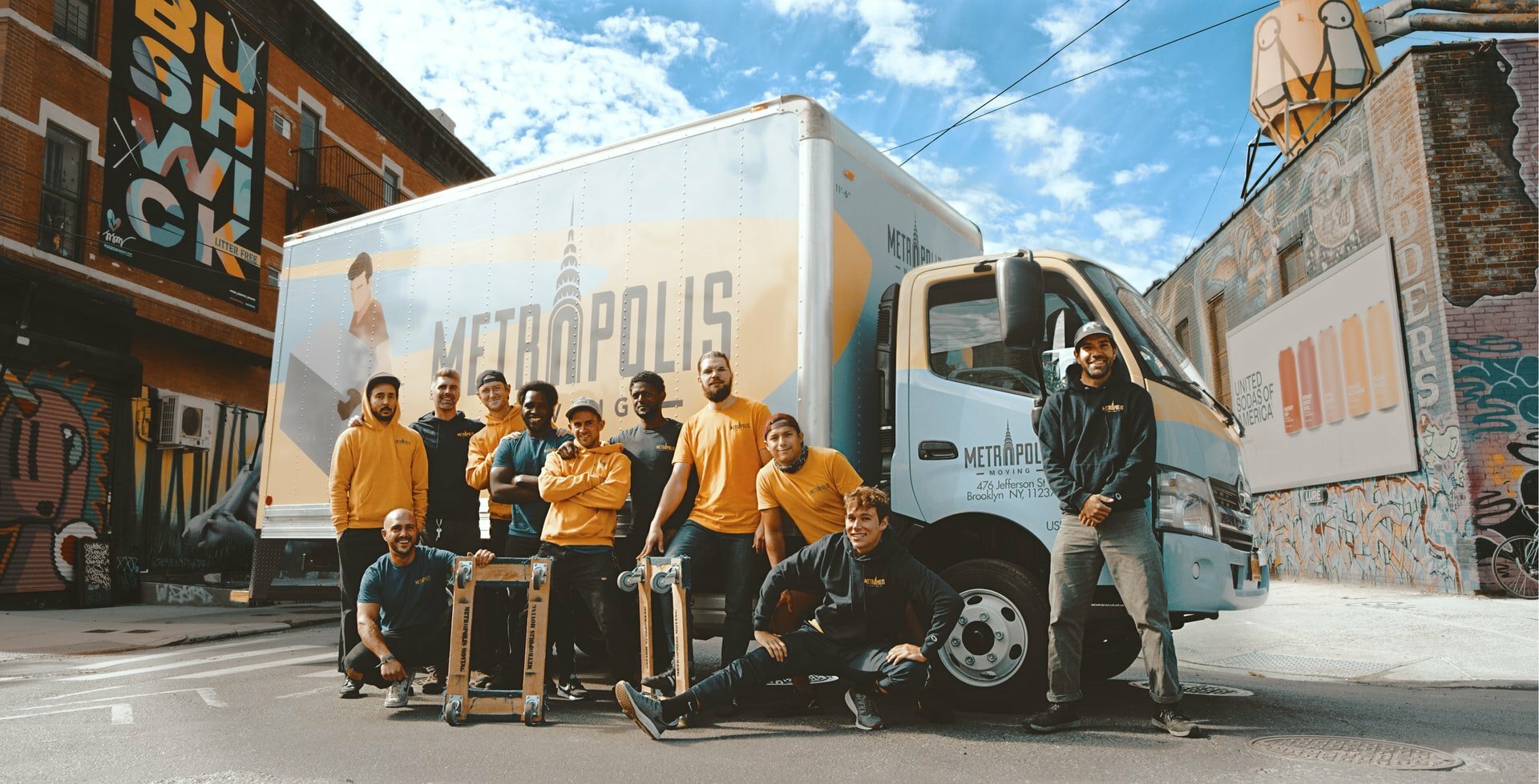 a group of people standing next to a truck