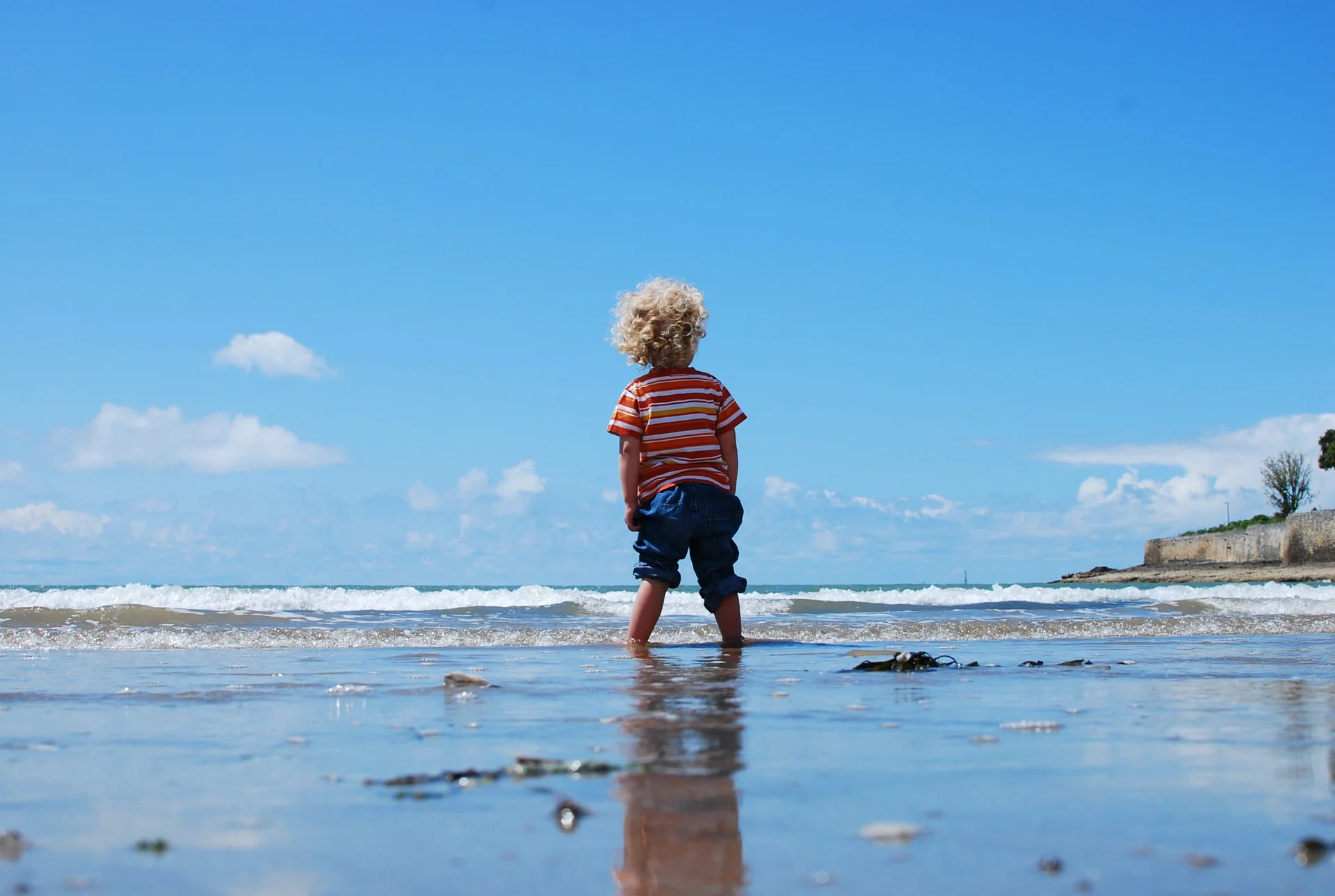 a boy walking on a beach