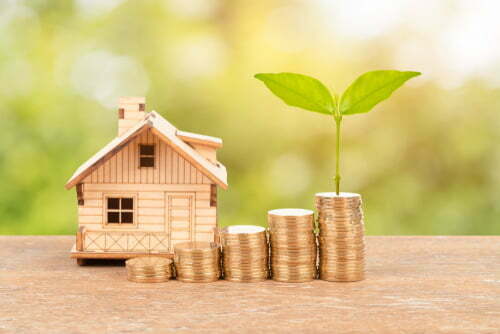 a small house with a tree in the background