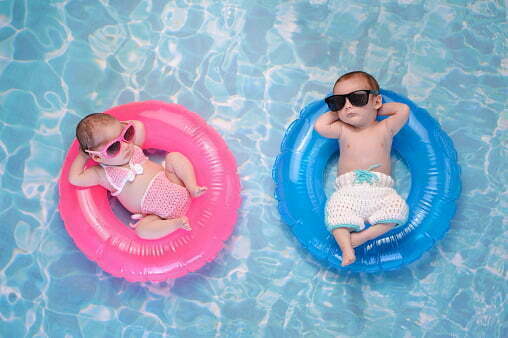 a couple of small pigs in a pool