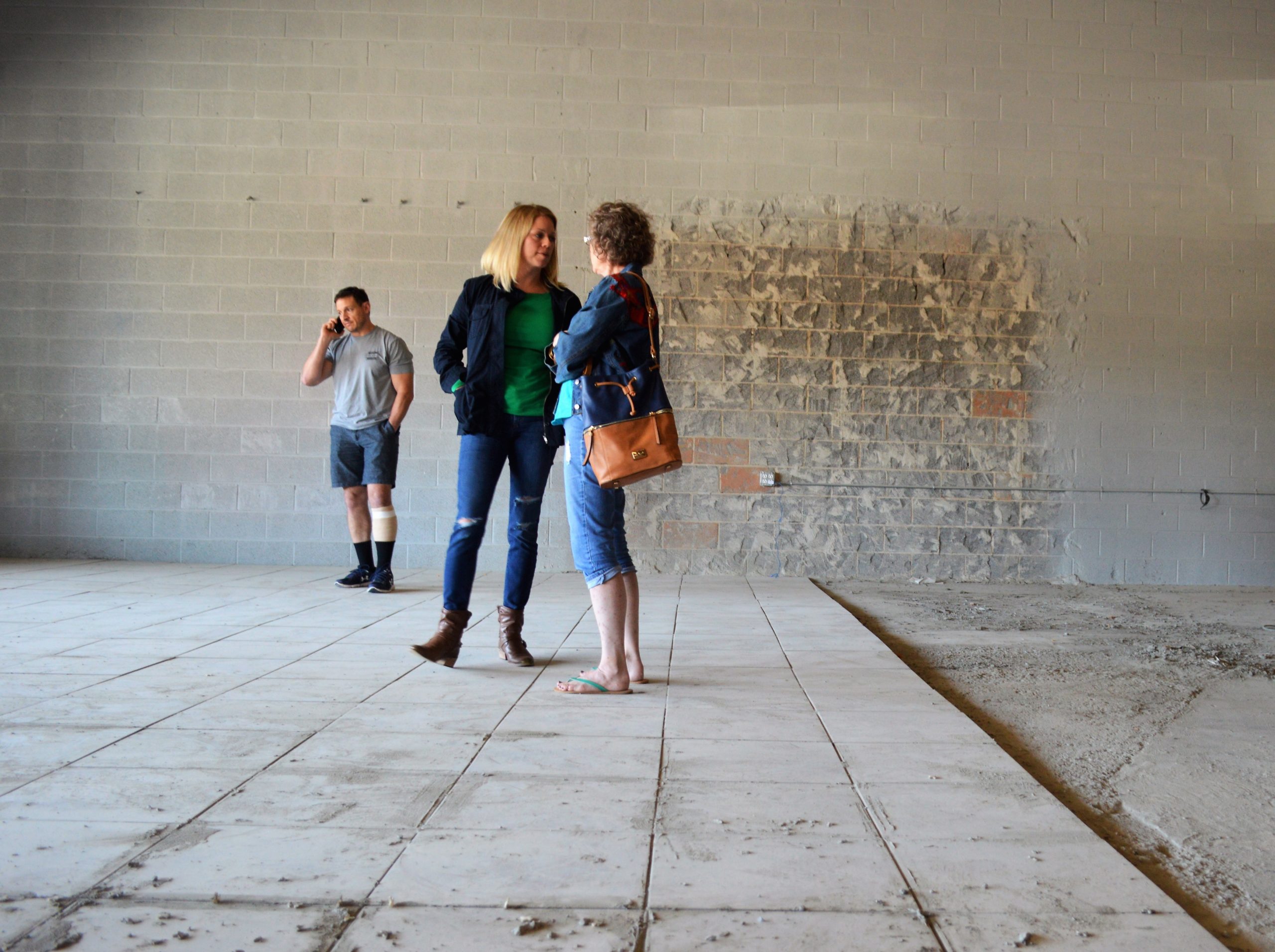 a group of people walking on a sidewalk