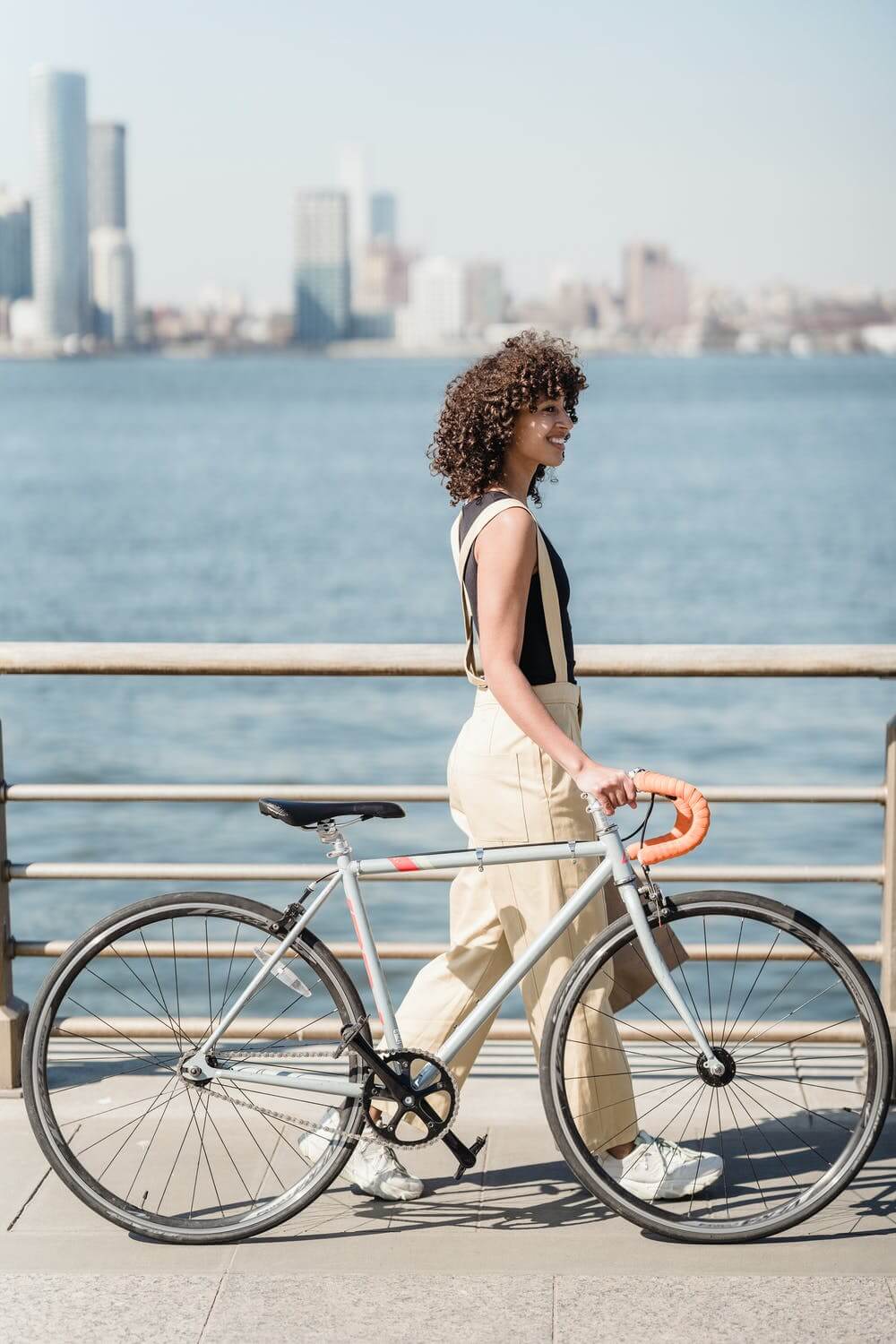 a person standing on a railing next to a body of water