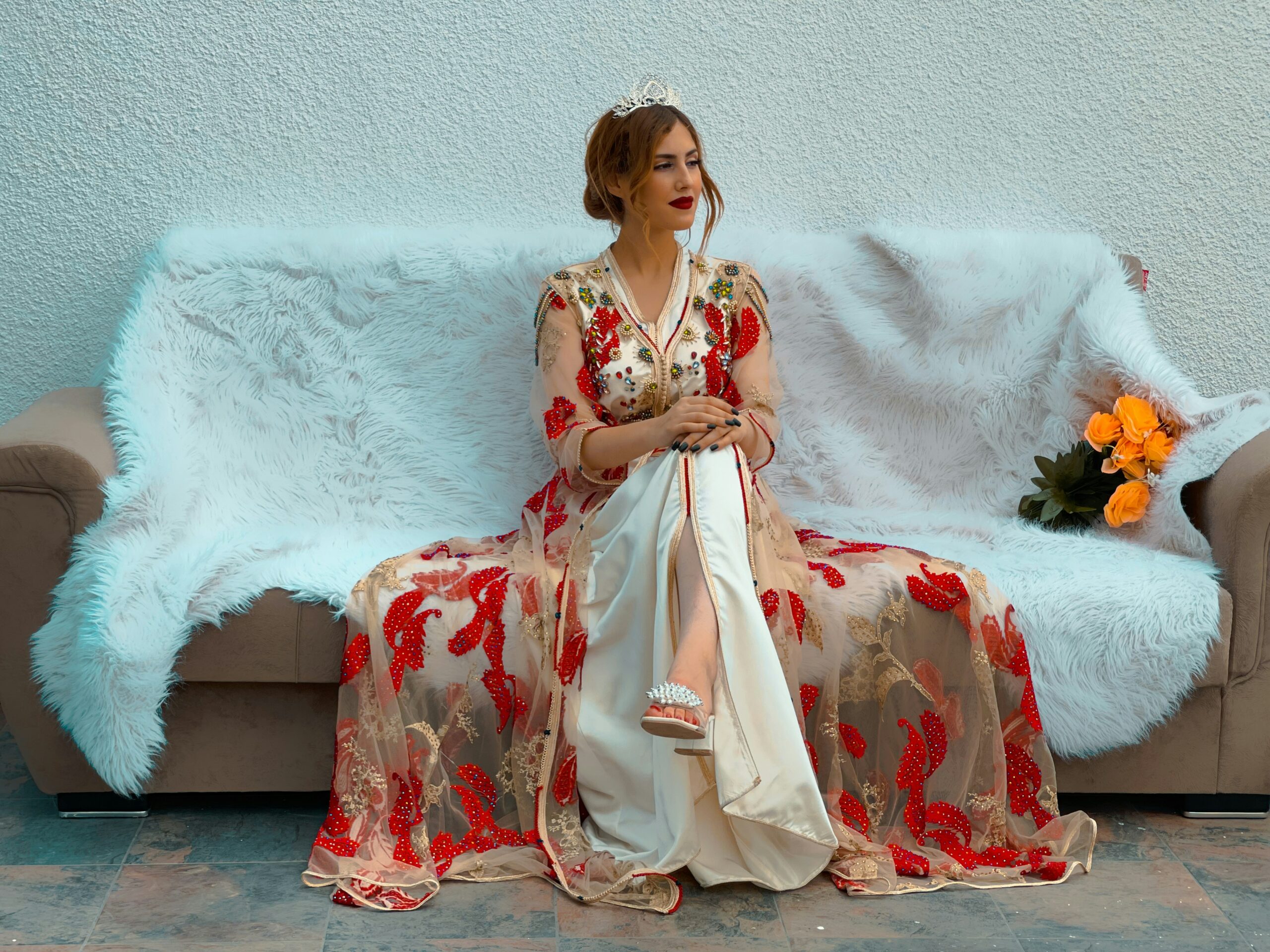 a woman in a dress sitting on a couch